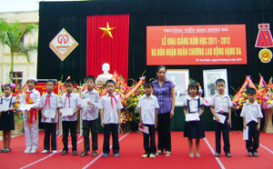 Đại diện Ngân hàng NN& PTNT tỉnh trao học bổng cho học sinh vượt khó trường tiểu học Sông Đà (TPHB).
