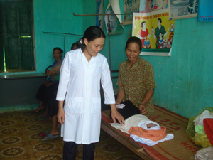 Cán bộ Trạn y tế xã Thanh Hối thăm khám, chăm sóc sức khỏe cho trẻ em.