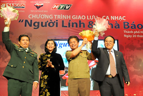 Phó Bí thư Thành ủy TPHCM Nguyễn Thị Thu Hà tặng hoa chúc mừng các vị khách giao lưu trong chương trình “Người lính và nhà báo”.