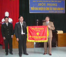 Thừa ủy quyền, đồng chí Bùi Văn Cửu, Phó Chủ tịch UBND tỉnh trao Cờ của Bộ Tư pháp tặng đơn vị xuất sắc trong phong trào thi đua.