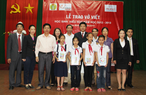 Đại diện lãnh đạo LDLĐ tỉnh, Công ty Prudential Việt Nam trao vở cho các em học sinh trường tiểu học xã Dân Chủ (TP Hòa Bình).