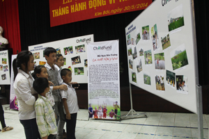 Trẻ em huyện Kim Bôi tìm hiểu các hình ảnh về ngôi nhà an toàn, tiêu chí xã, phường phù hợp với trẻ tại triển lãm ảnh trong tháng hành động vì trẻ em năm 2014.