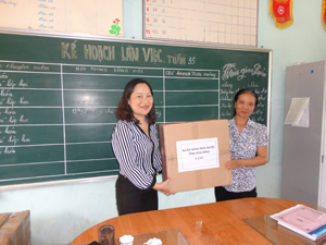 Đồng chí Vũ Thị Song Nguyệt, Phó giám đốc NHNN Hòa Bình trao tặng quà cho trường tiểu học Xã Sơn Thủy.